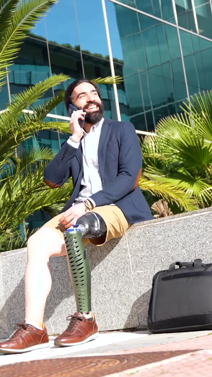 Man with prosthetic leg talking on the phone outdoors