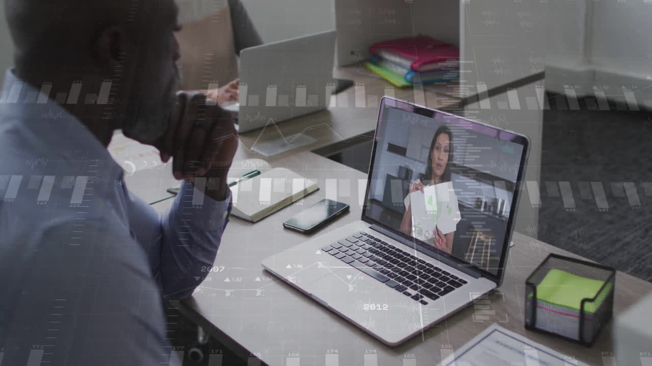Businessman in video conference with financial data animation overlay on screen