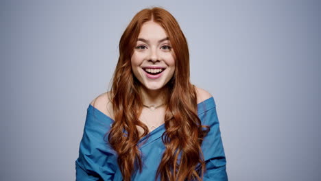 surprised woman opening mouth on gray background. cute girl posing in studio