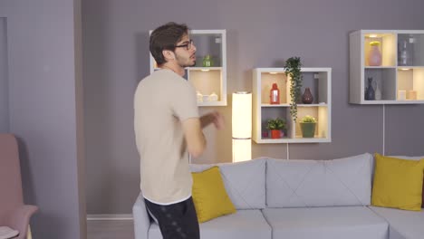 Cheerful-young-man-is-dancing-at-home.