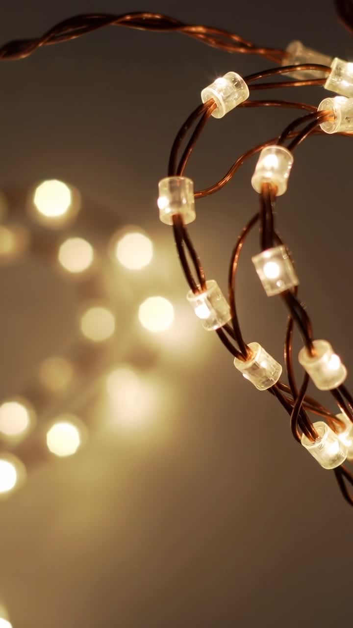 Vertical video: Opening microLED lights glowing on twisted copper wires decorating wall, copy space