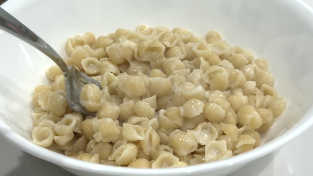 POV eating creamy white boxed mac n cheese shells, a childhood favorite American comfort food made with healthy ingredients