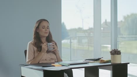 business woman relaxing with coffee. tired lady sitting with laptop computer.