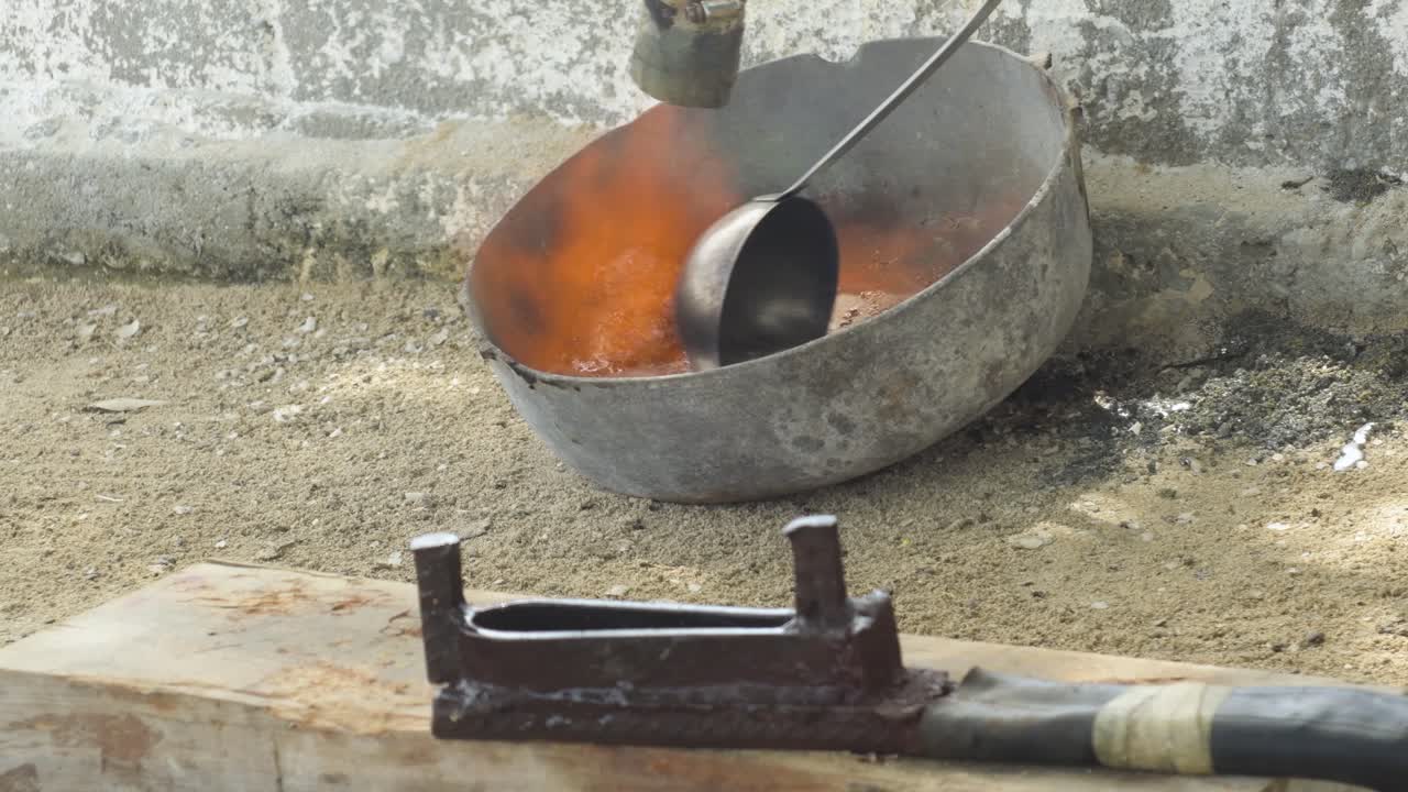 Lead melting in old pot over the sand, remove impurities with ladle before place in sinker mold