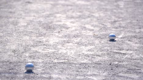petanque sport, player throw ball to point ball in competition