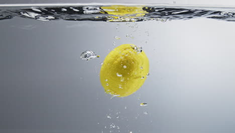 lemon falling in water. close up, slow motion