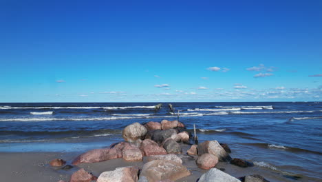 a rocky beach with waves coming in and out of the water