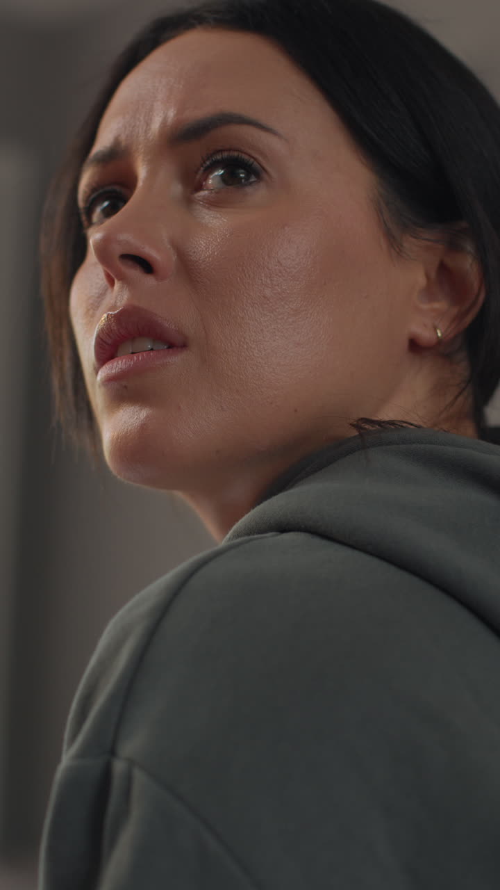 Vertical Video Rear View Of Depressed Or Anxious Woman Turning Around Sitting Indoors On Sofa At Home 1