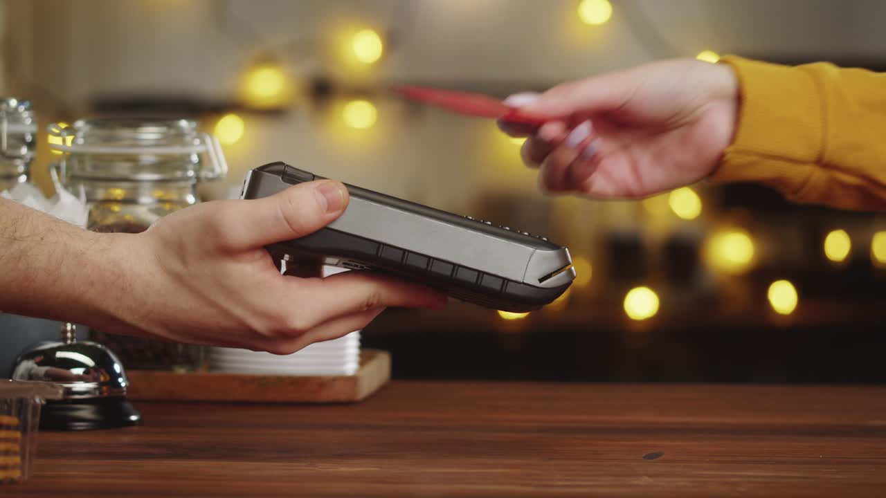 Paying with credit bank card in cafe. Touch-free and contactless food shopping in restaurant. NFC technology concept. Buying coffee, hot drink.