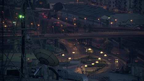 night traffic in algiers city, algeria, cinematic view with satellite on roof in foreground