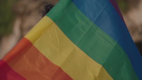 Man holding rainbow pride flag