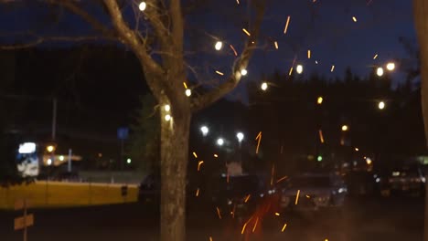 fire pit flame rising into sparks panning shot