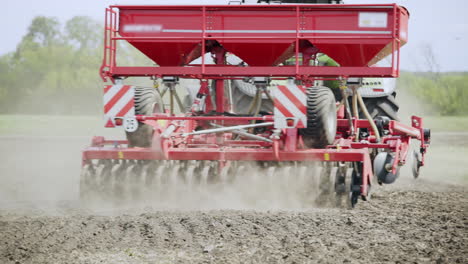 Sowing-machine-working-on--plowed-field.-Farming-equipment-for-field-sowing