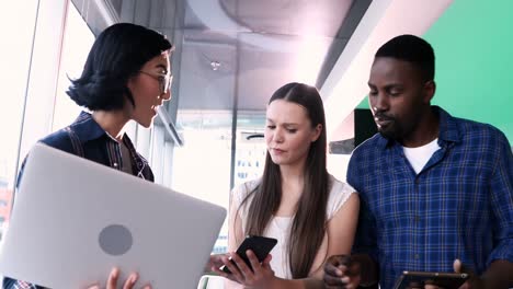 male and female executives discussing over electronic devices 4k