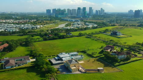 aerial footage of a landscape with housing estate and blue sky in the background