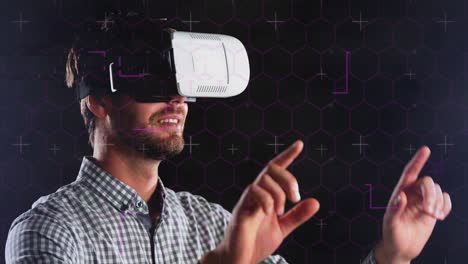 Hexagonal-shapes-and-light-trails-over-caucasian-man-wearing-vr-headset-against-black-background