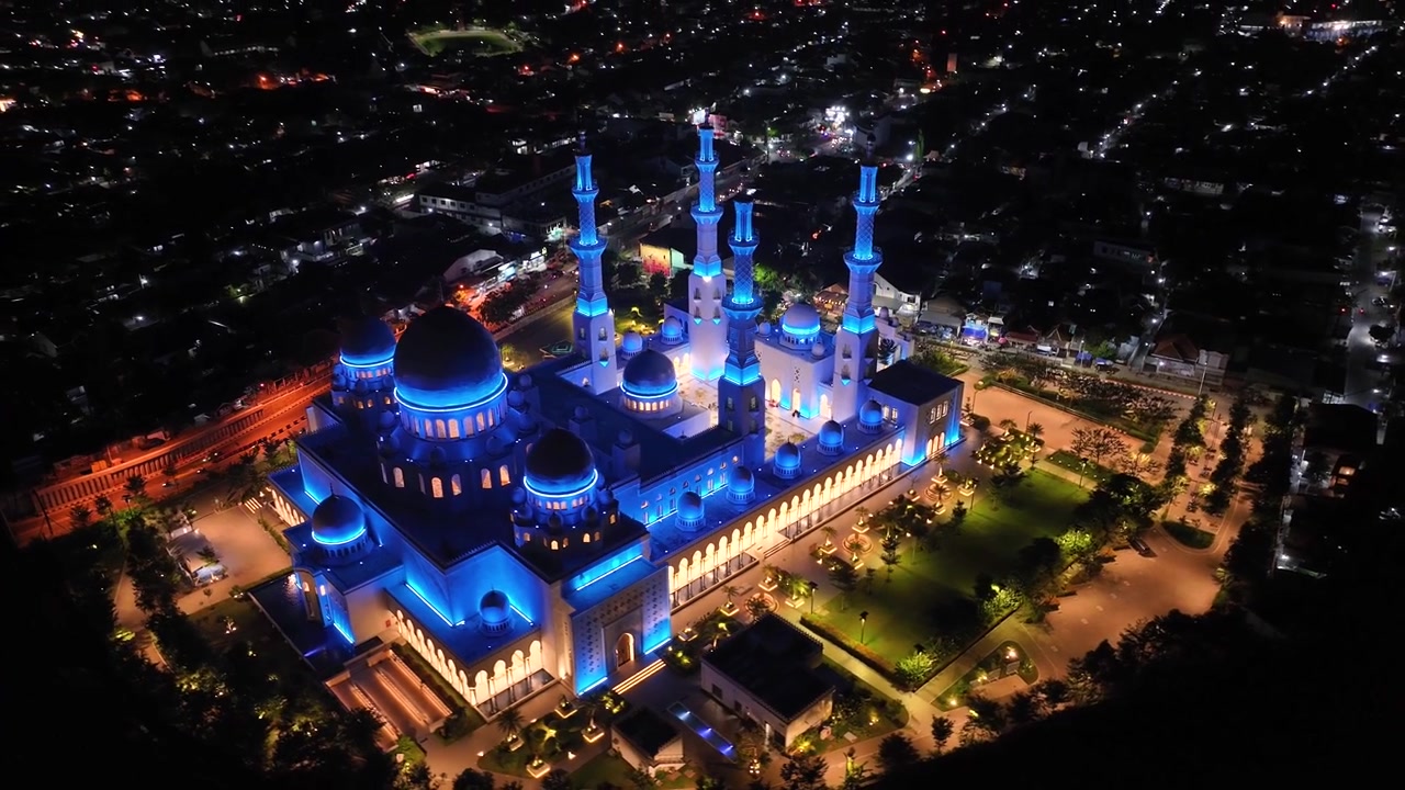 Sheikh Zayed Great Mosque in Solo city, Indonesia. Beautiful night aerial reveal important landmark.