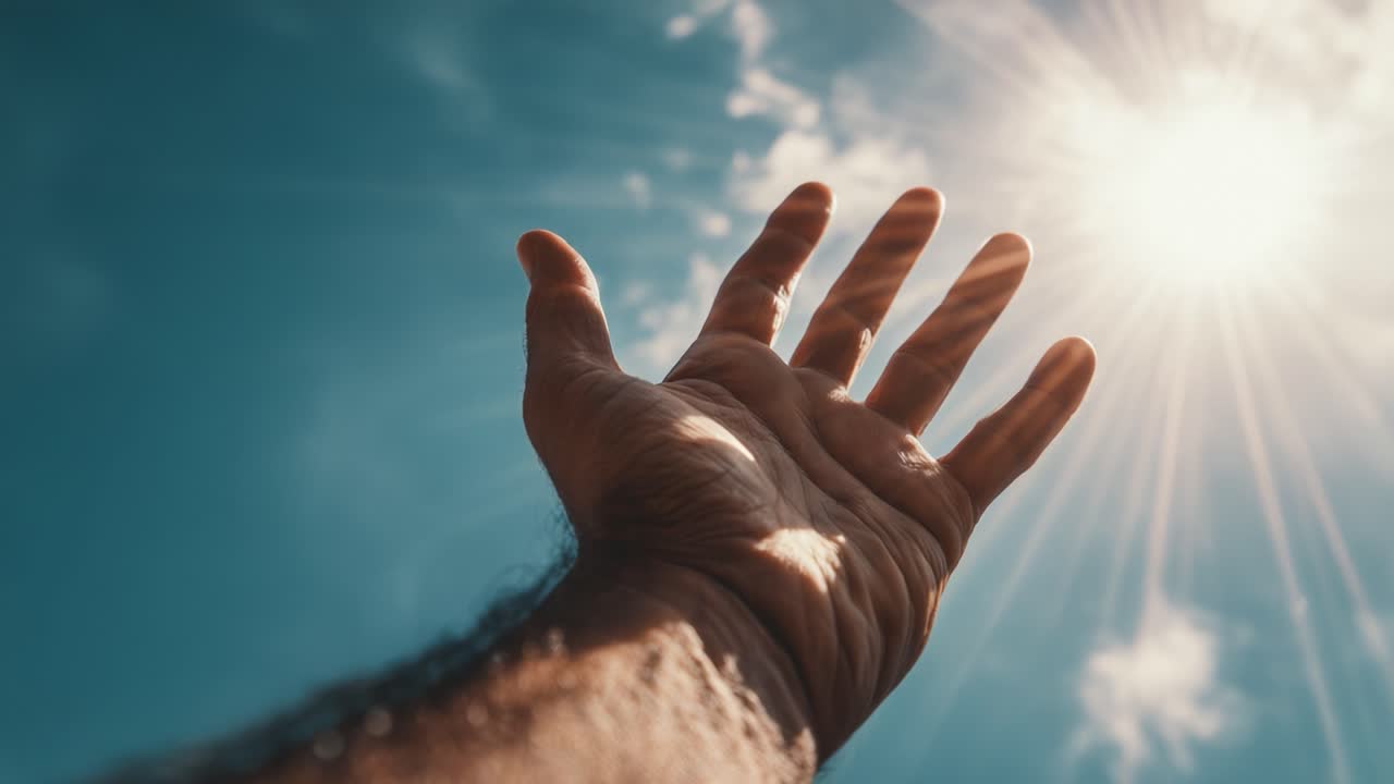 Reaching Towards the Sky: A Hand Extended in Search of Light and Hope Under a Brilliant Sunlit Sky