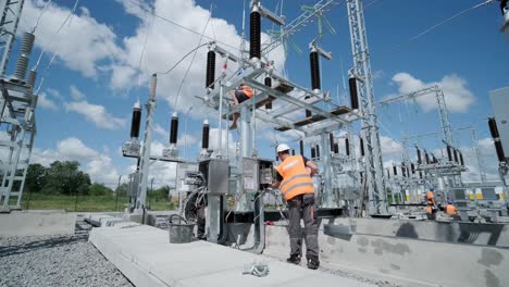 electrical engineers inspect the electrical systems at the equipment control cabinet