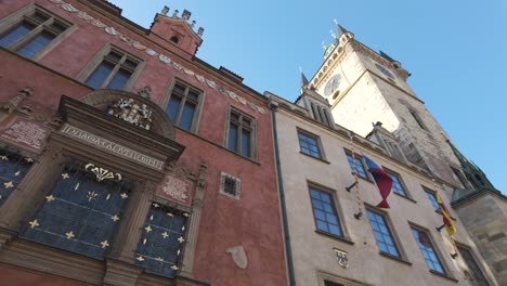 the famous astronomical clock tower in prague under a clear blue sky, shot from a low angle