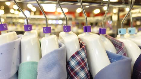 close-up of shirts hanging on a rack in a store