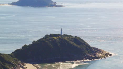ilha do mel island's lighthouse mountain on rocky hill surrounded by ocean waters, paraná, brazil