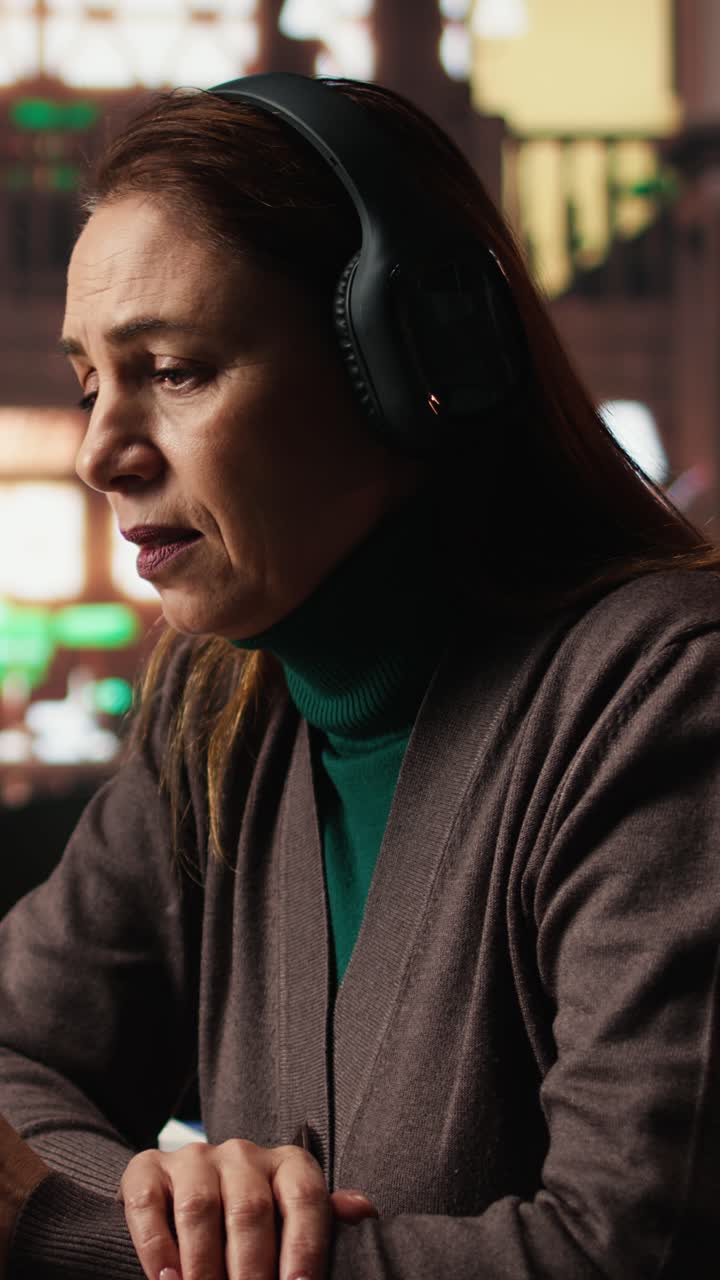 Vertical Video Female student participates in online class via laptop in a campus library