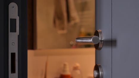 close-up of a silver door handle on a gray door