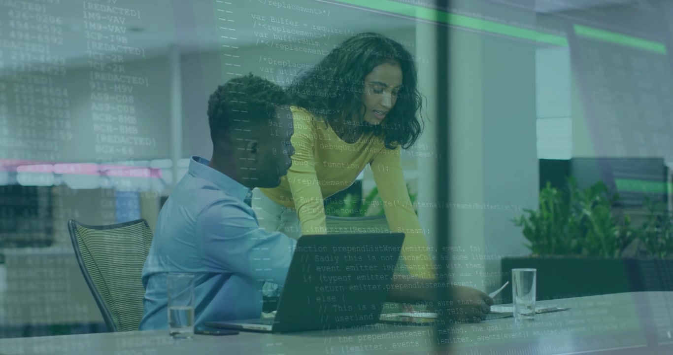 Software Developers Collaborating on Code in Modern Office