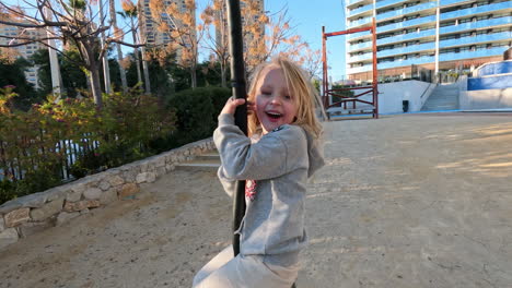 kid enjoying exciting rope swing ride on the playground