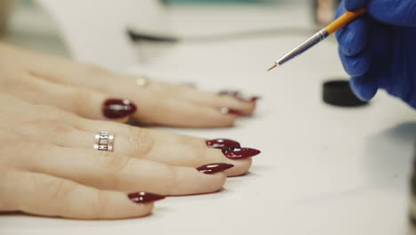 woman getting a manicure with red nail polish