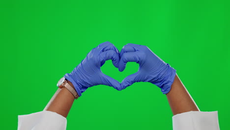 Hands,-heart-and-medical-with-a-doctor-on-a-green