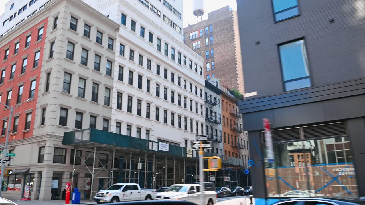 New York, USA, 5 August 2025: Historic buildings and construction site on New York street. Architecture of mixed styles on a city street with safety barriers and construction