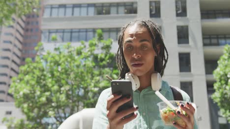 Mixed-race-man-using-his-phone-outside