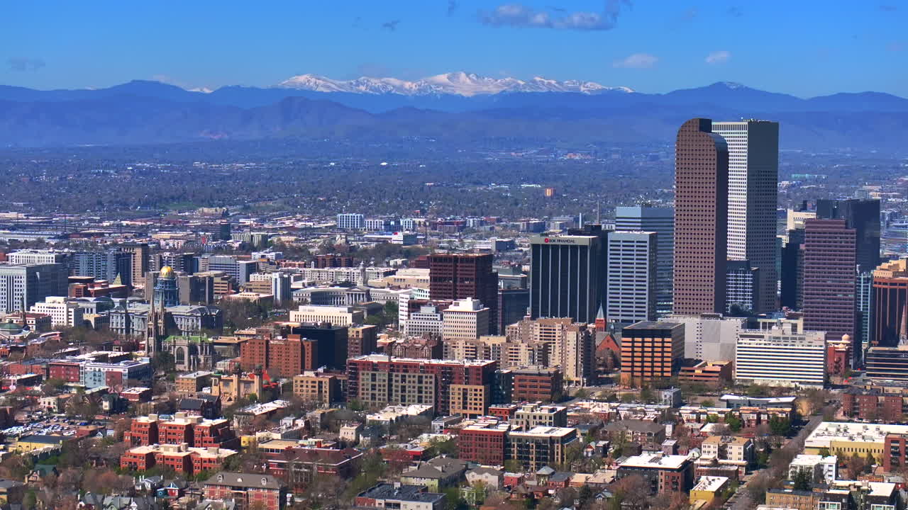 City Park Lodo Downtown Denver Cityscape Landscape Colorado aerial drone view tall skyscraper buildings city living apartments spring summer Mount Blue Sky front range mountains forward up motion