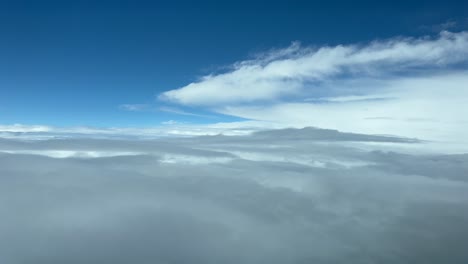 immersive pilot pov from an airplane cockpit flying over layers of clouds