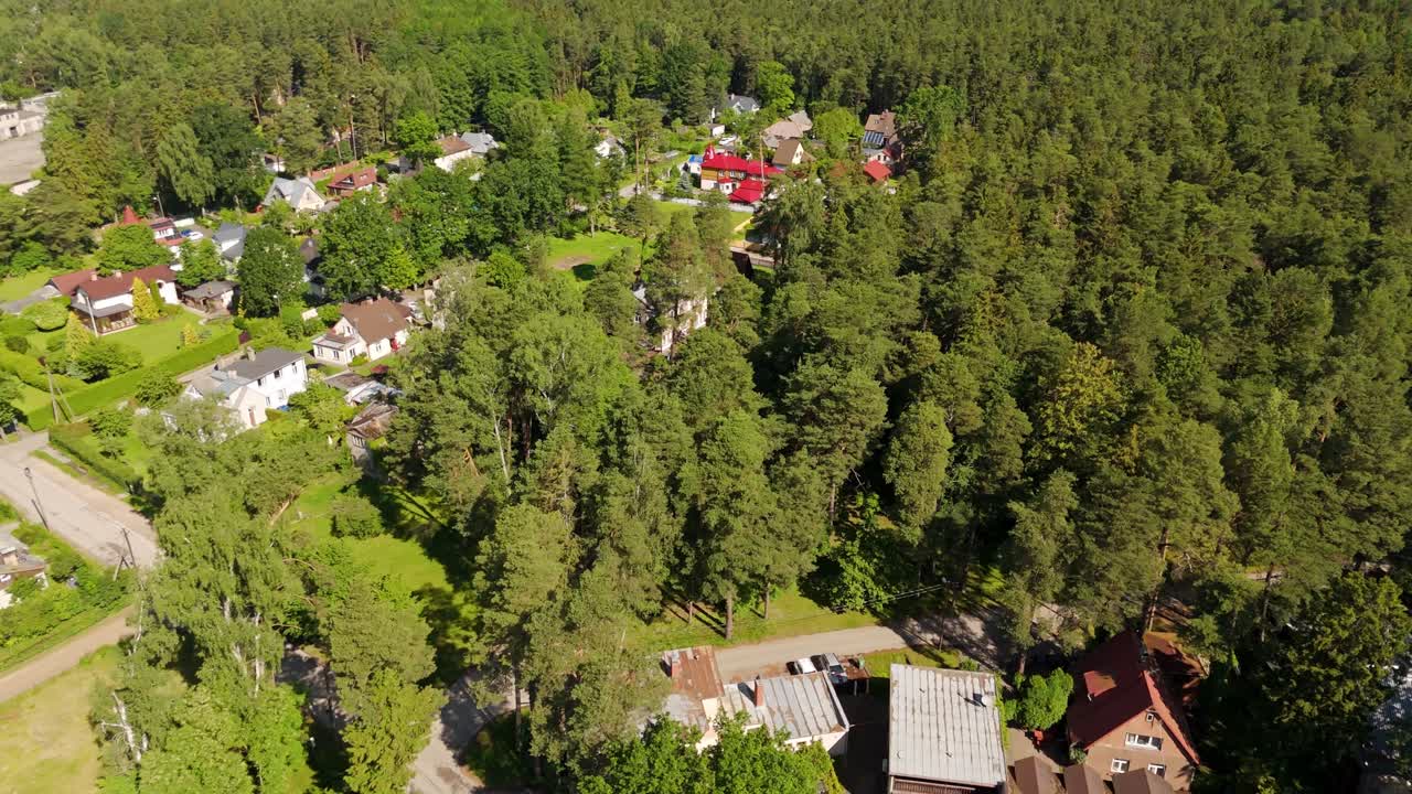 Scenic tilt view of Jurmala’s beach neighborhood nestled among lush green Baltic forests