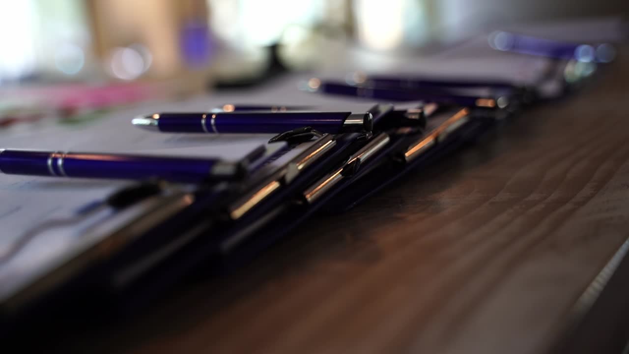clipboards lie on a table with blue boots