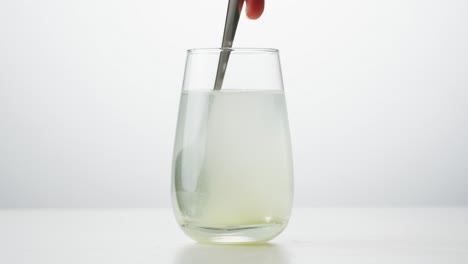 mixing a powdered supplement in a glass