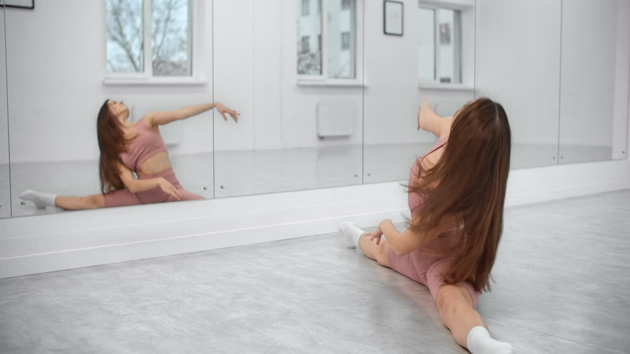 Woman practicing dance stretches in a studio