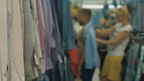 woman tries on a shirt in the mall