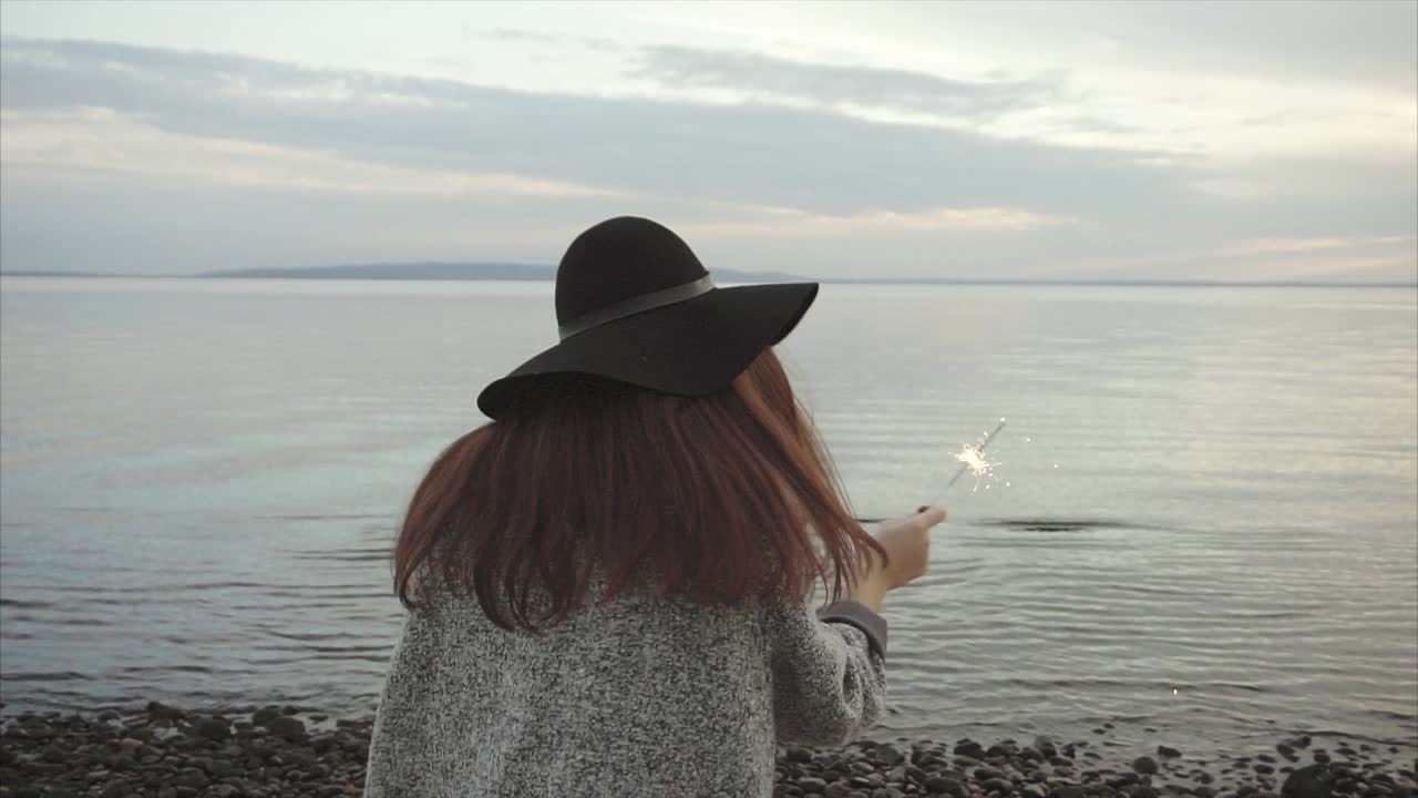 Woman with Sparkler on the Beach