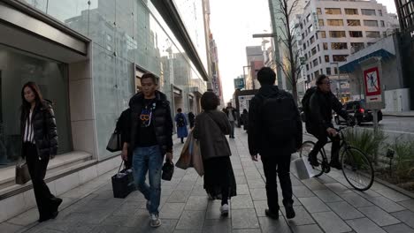 pedestrians walking along a busy urban street