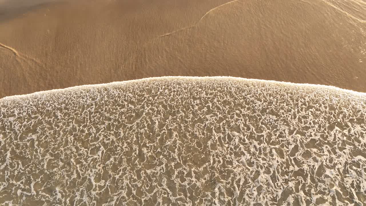 Aerial footage looking down on the beach at Fingal in Australia