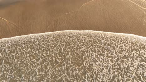 aerial footage looking down on the beach at fingal in australia