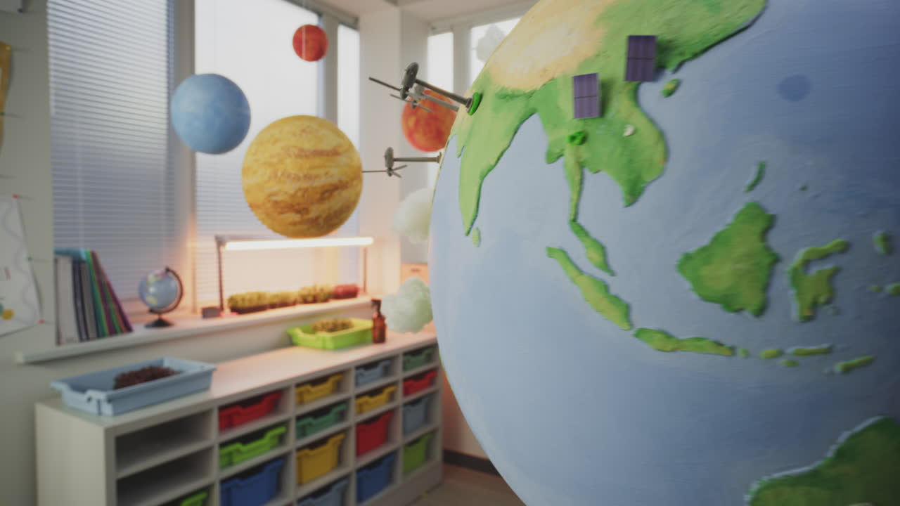 STEM Classroom Close Up of Earth Model with Miniature 3D Models of Wind Turbines and Solar Panels