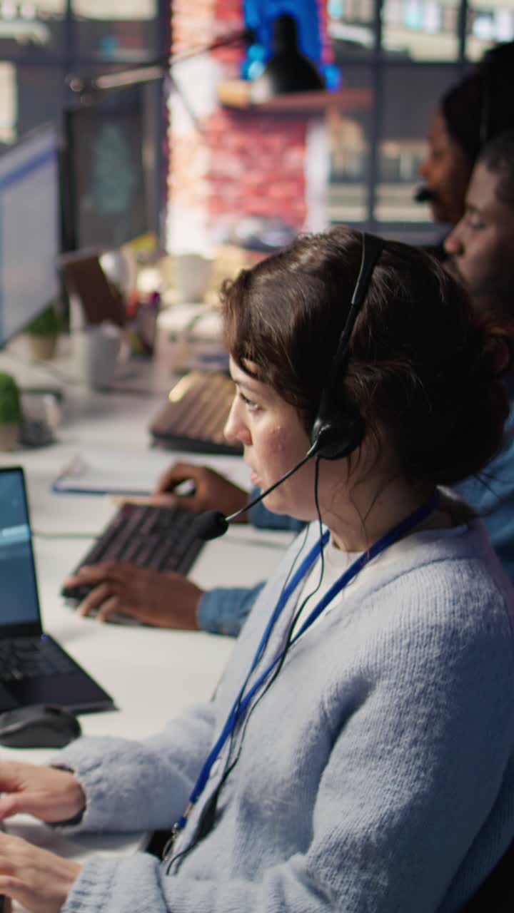 Vertical video Technical support specialist in call center office using AI chatbot