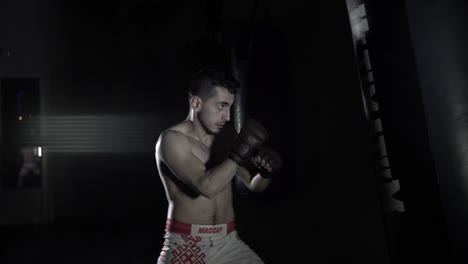 a man boxing a pear in the gym