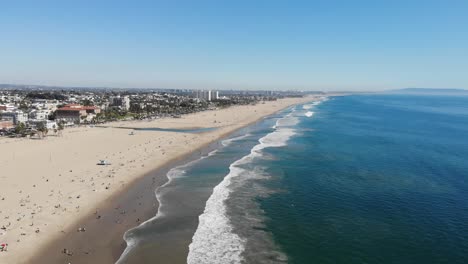 imágenes de drones tomadas desde 400 pies de la prístina playa de santa mónica en los ángeles, con olas rodando por la suave arena blanca