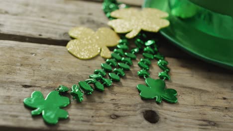 shamrocks and green hat with copy space on wooden table